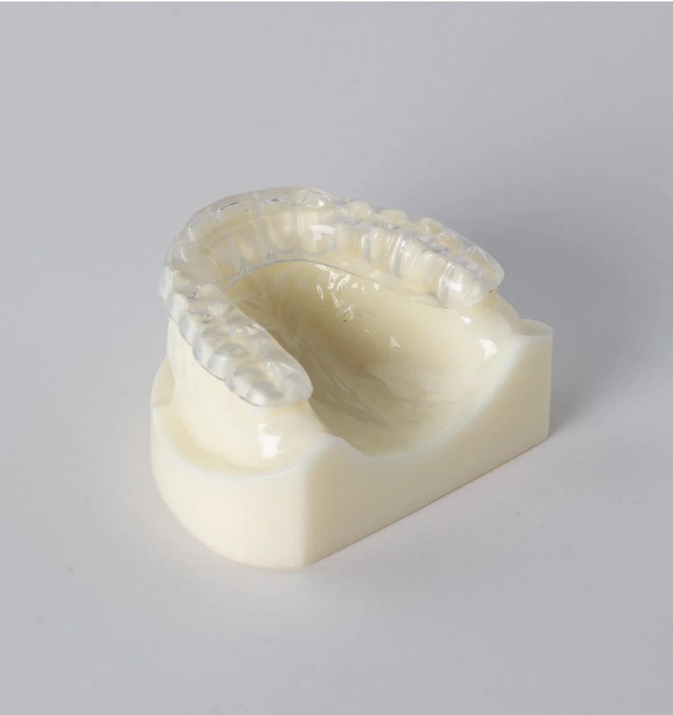 A custom clear dental splint on a model